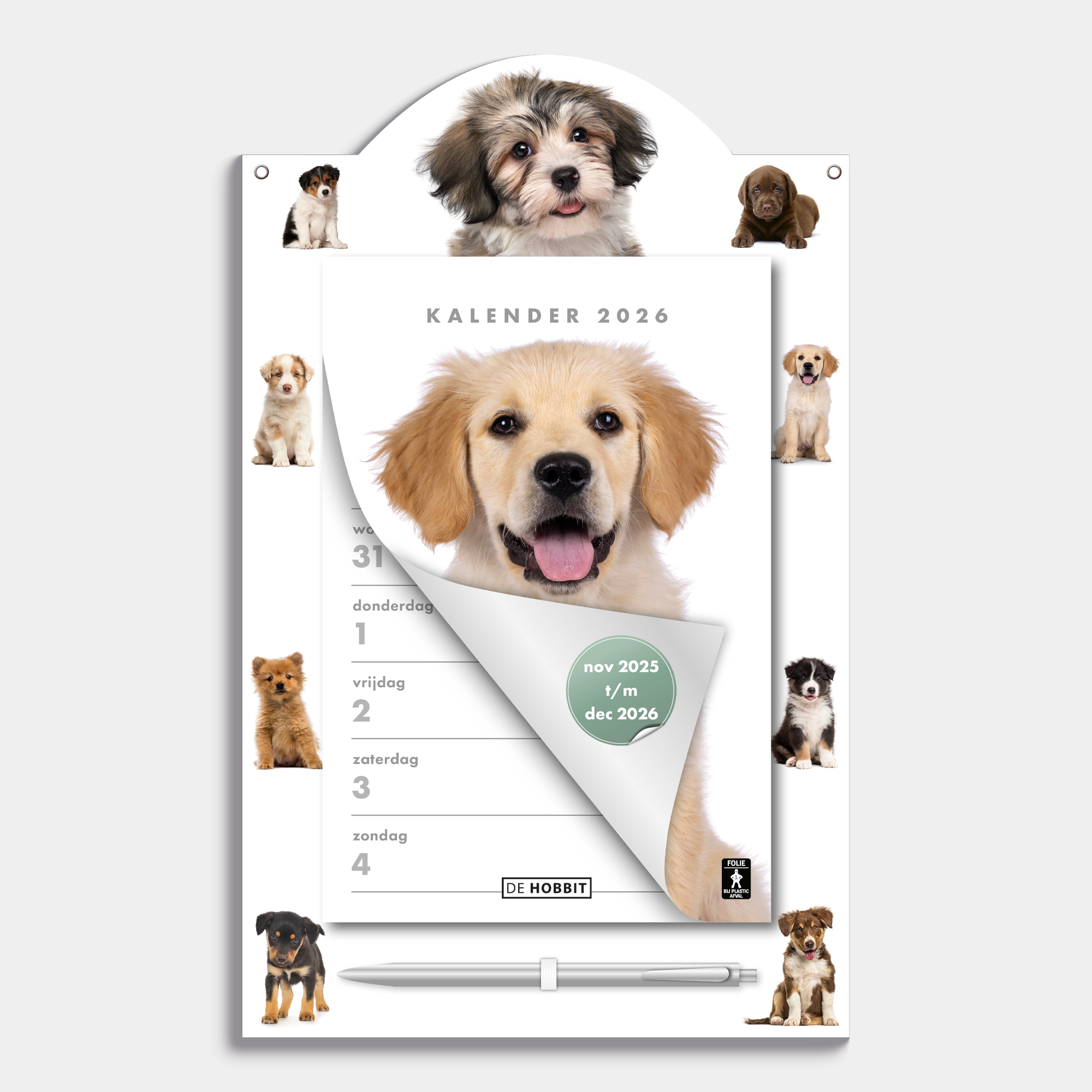 Scheurkalender 2026 op een kartonnen bord voorzien van foto's van lieve honden en puppies, met pen – vooraanzicht.