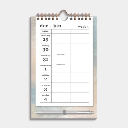 Duoplanner 2026 A5 met een dessin van aquarel in aardetinten op een kartonnen bord met pen – weekoverzicht.