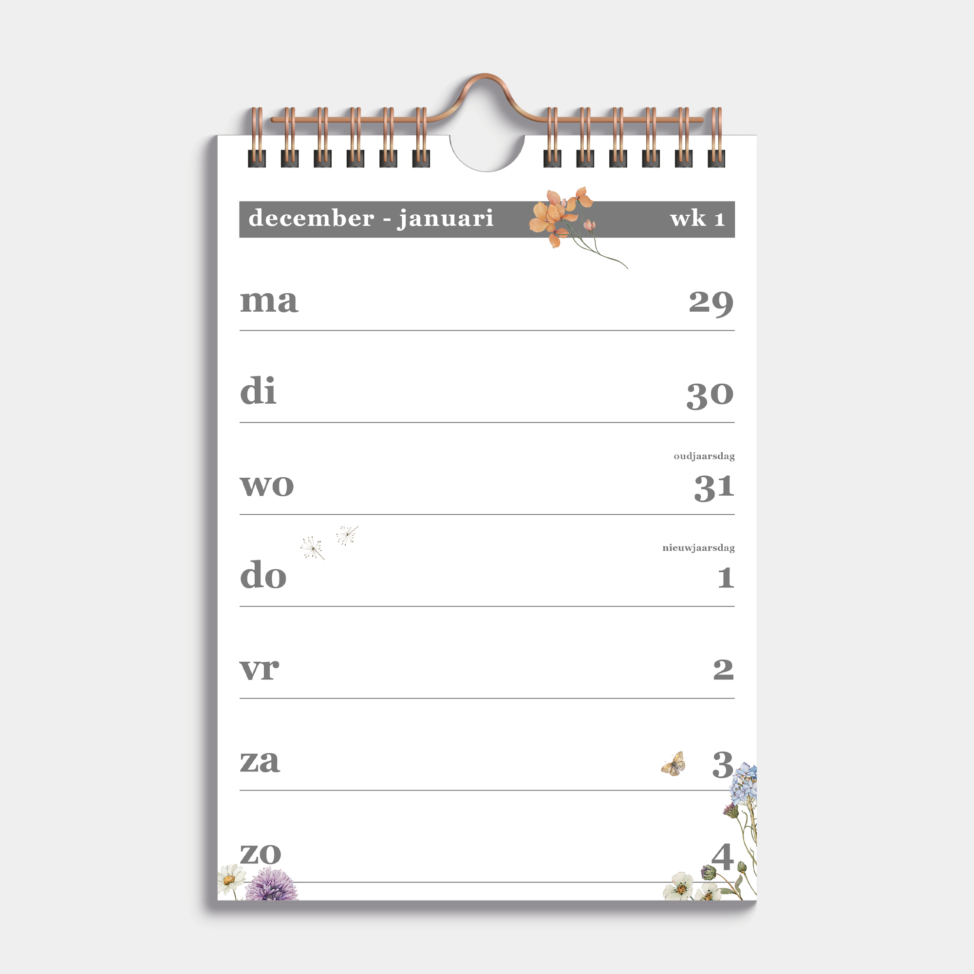 Weekkalender 2026 in A5 formaat met een subtiele print van weidebloemen, gebonden in een koperkleurige metalen spiraal en hanger – binnenwerk met weekoverzicht.